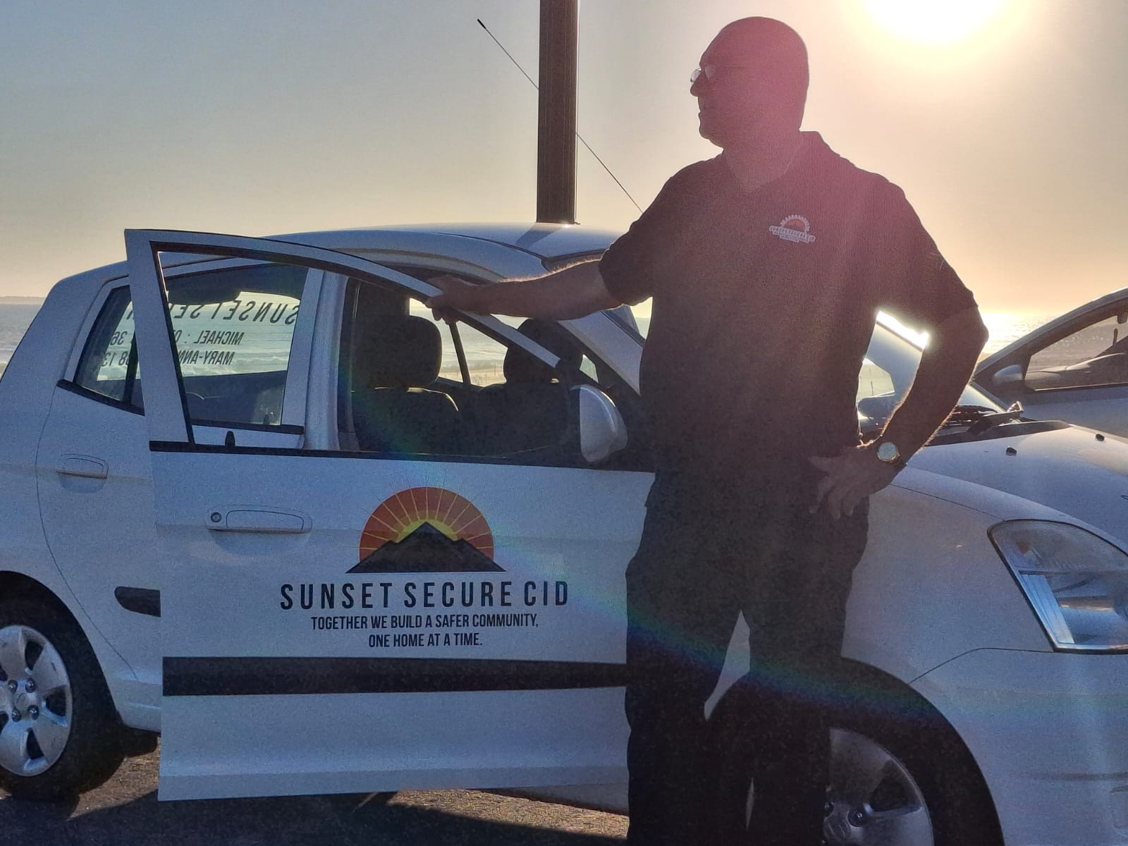 CEO with Sunset Secure CID patrol vehicle at sunset